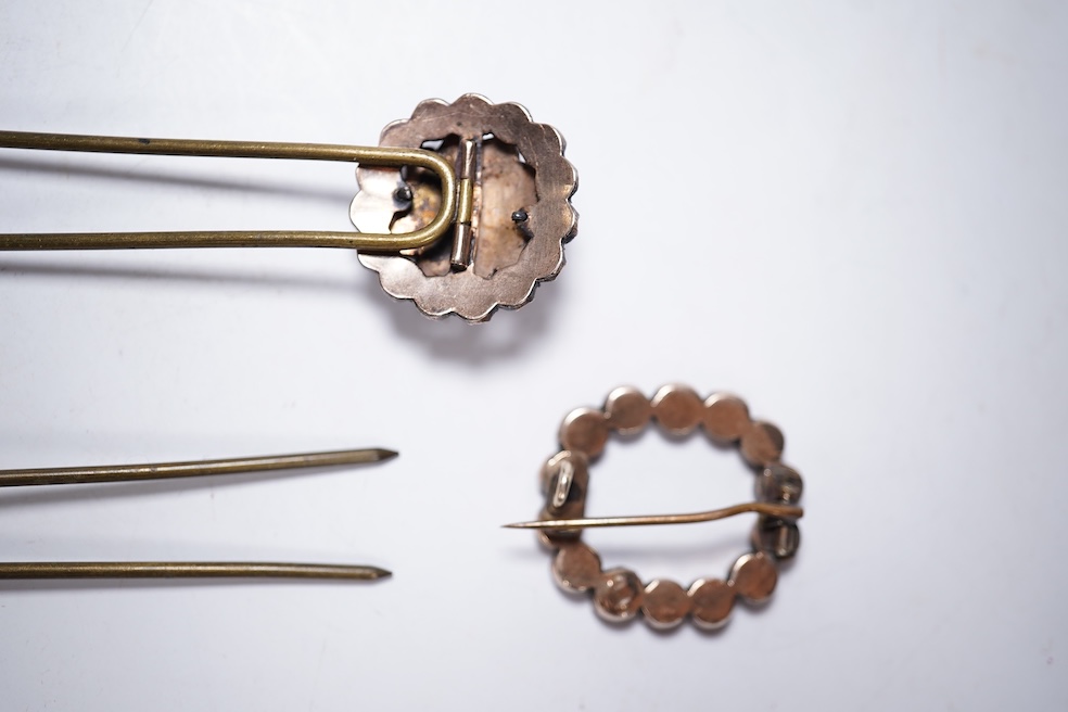 A Victorian yellow metal and garnet cluster set open work brooch, 27mm, together with two garnet cluster set hair ornaments. Condition - poor to fair
